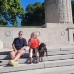 A busy Summer at The Hive at 52. Image of Lucy, Harro and their dog Rex at the USA memorial in Mountfaucon, France