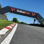 B&B in Cheshire , image is of part of Oulton Park race circuit , the image shows a banner stating Oulton Park and part of the tarmac race track